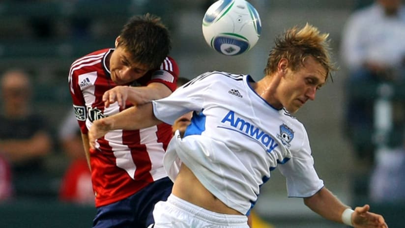 Chivas USA's Jorge Flores (left) and San Jose's Brad Ring contend for a ball.