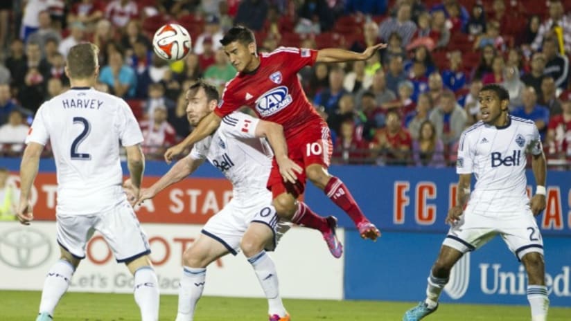 FC Dallas' Mauro Diaz challenges Vancouver Whitecaps players in Western Conference playoff game