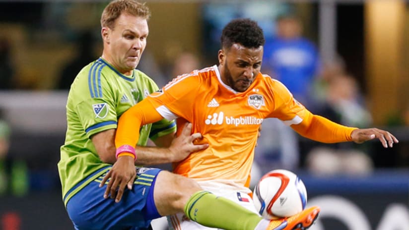 Chad Marshall (Seattle Sounders) attempts to win the ball from Giles Barnes (Houston Dynamo)