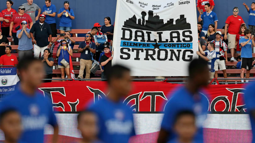Supporters hold "Dallas Strong'' sign at FC Dallas-Chicago Fire game - 7-16-16