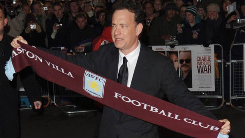 Actor Tom Hanks holds up an Aston Villa scarf