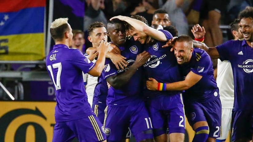 Jonathan Spector - Orlando City - is mobbed by smiling teammates after scoring