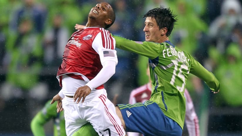 Portland's Jeremey Hall (left) and Seattle's Alvaro Fernandez jump for an aerial ball.