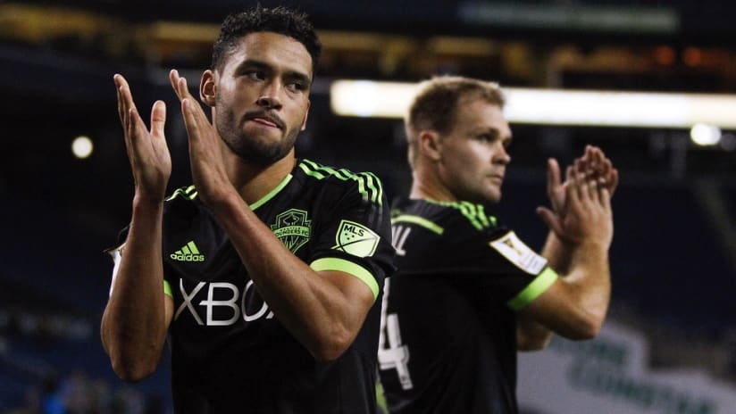 Seattle Sounders attacker Lamar Neagle applauds the crowd