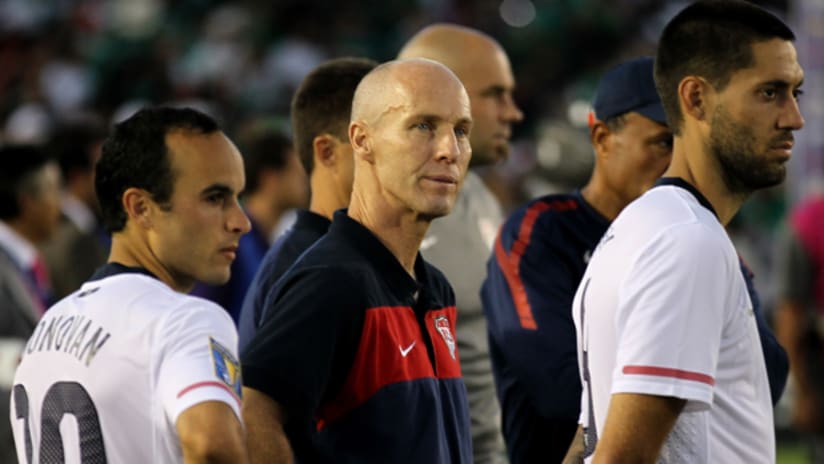 US manager Bob Bradley looks on with Landon Donovan and Clint Dempsey after the US lose to Mexico