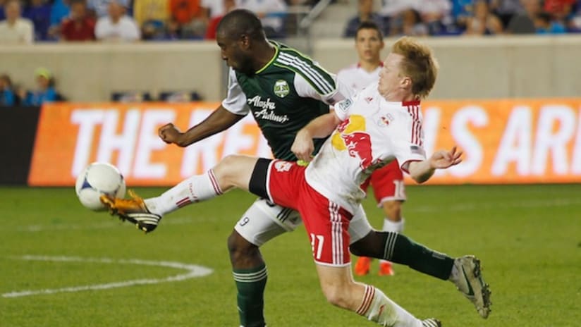 Bright Dike and Dax McCarty battle for the ball