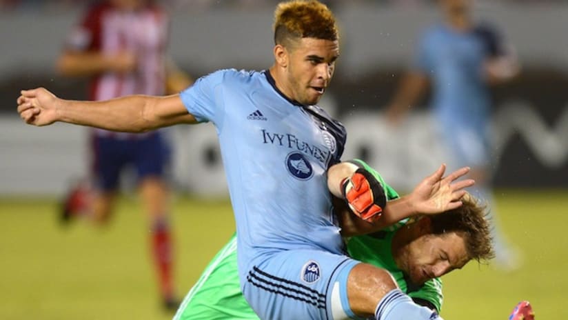Dom Dwyer scores a goal for Sporting KC against Dan Kennedy of Chivas USA