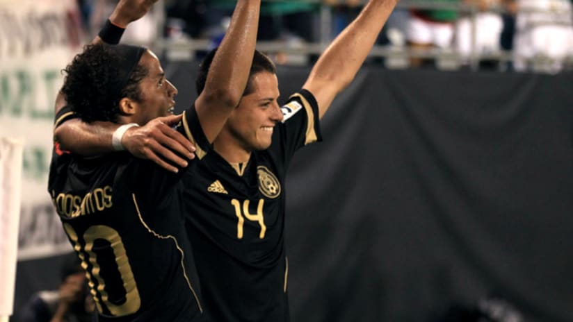 Giovani dos Santos (left) and Javier Hernandez led Mexico in a 5-0 rout of Cuba.