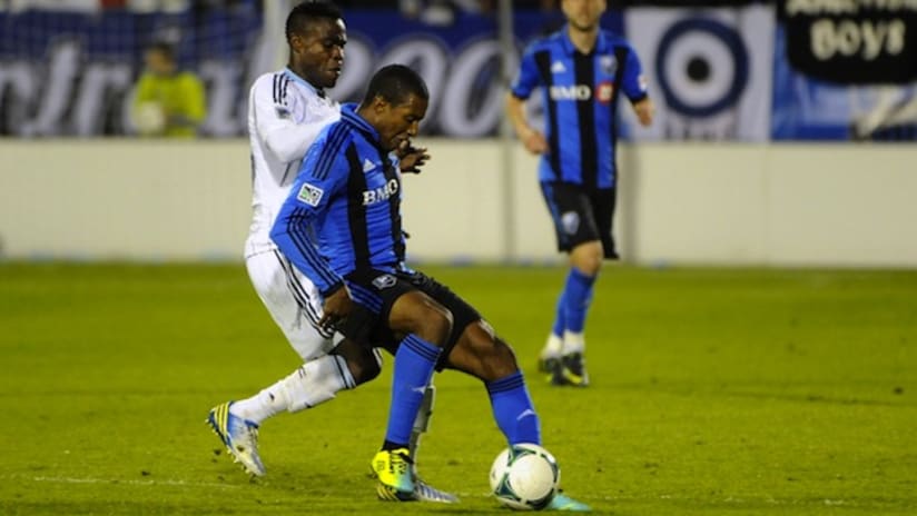 Patrice Bernier holds the ball up against Gershon Koffie