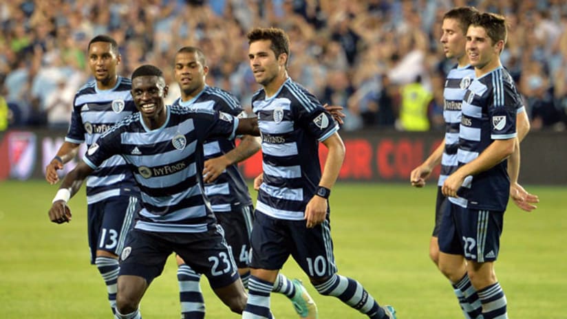 Sporting KC midfielder Benny Feilhaber celebrates with teammates after scoring a penalty kick