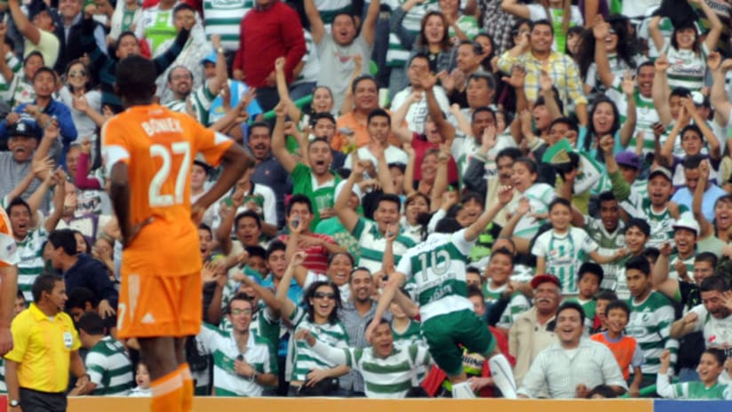 Herculez Gomez celebrates his goal while Boniek Garcia looks on