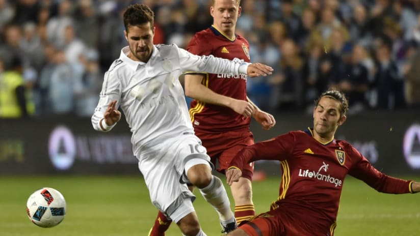 Real Salt Lake's John Stertzer goes in to tackle Sporting Kansas City's Benny Feilhaber