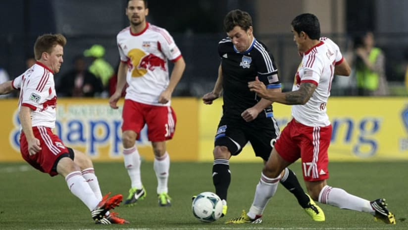 Mike Fucito advances the ball on Dax McCarty and Tim Cahill