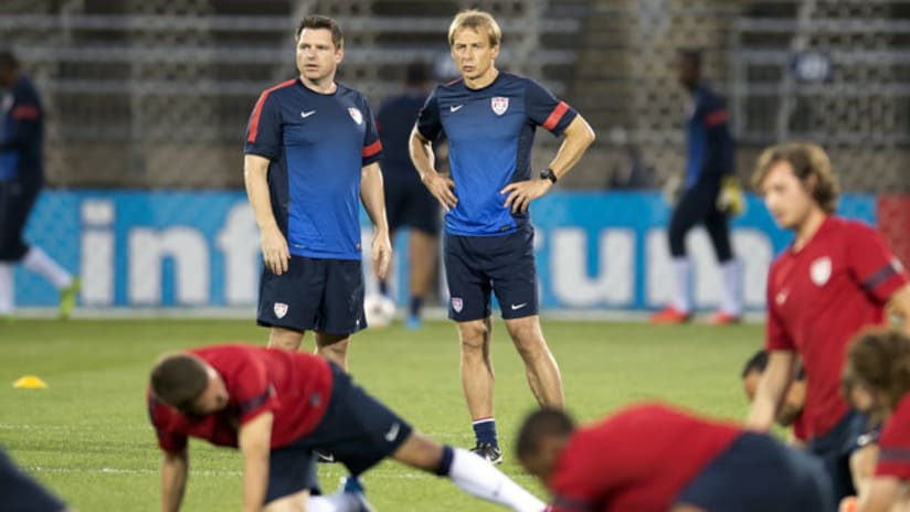 Jurgen Klinsmann watches as the USMNT stretches