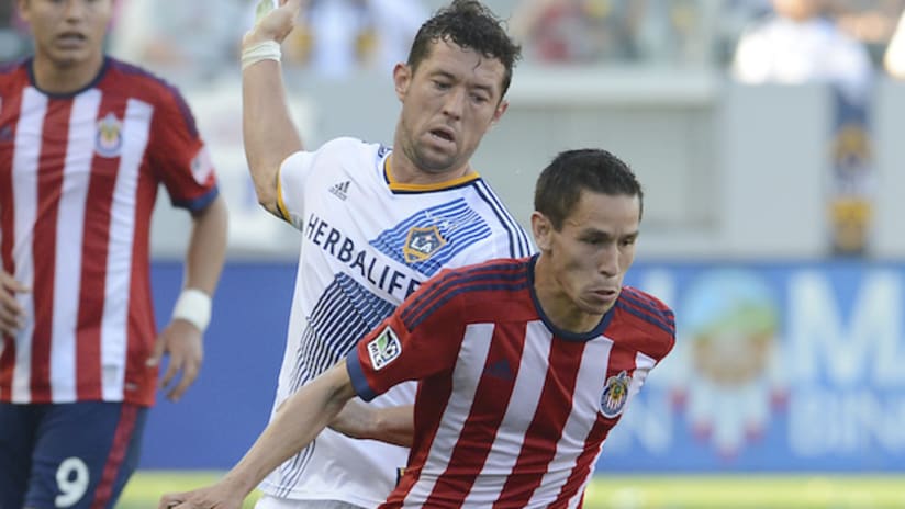Chivas USA's Eric Avila shields the ball from the LA Galaxy's Dan Gargan