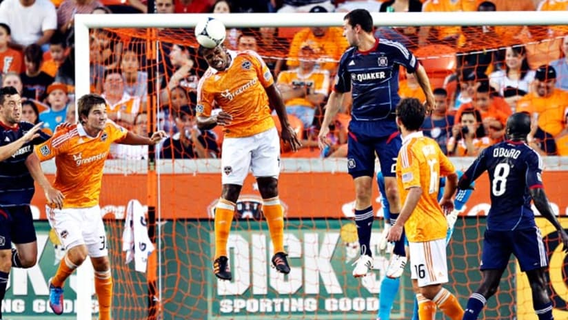 Houston's Jermaine Taylor clears a corner kick against Chicago.