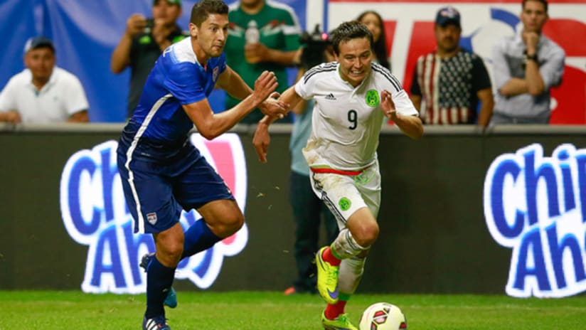 Omar Gonzalez of the USMNT tries to keep up with Erick "Cubo" Torres of Mexico