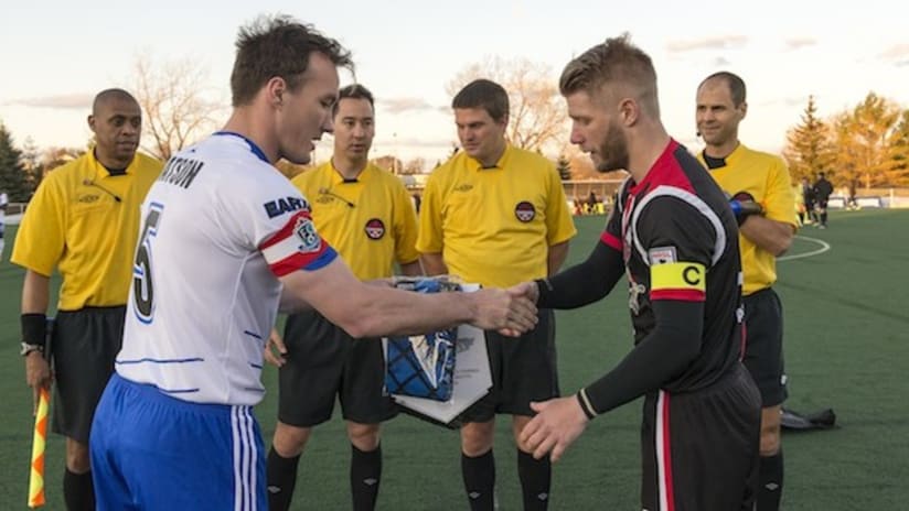 The FC Edmonton and Ottawa Fury captains shake hands before their ACC match
