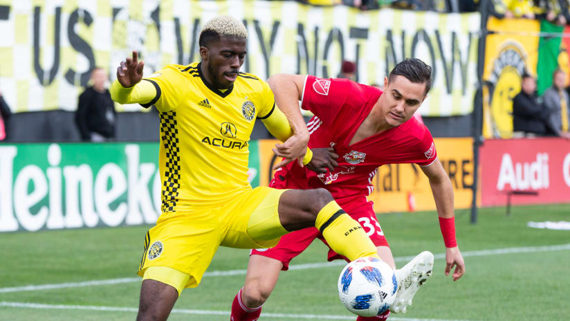 Gyasi Zardes - Columbus Crew SC - fights for the ball with Aaron Long - New York Red Bulls