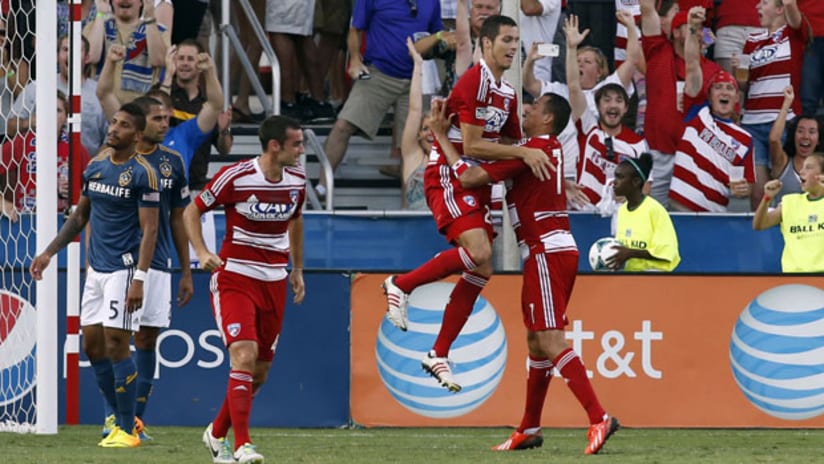 Matt Hedges jumps into Blas Perez's arms after FC Dallas' first goal on LA