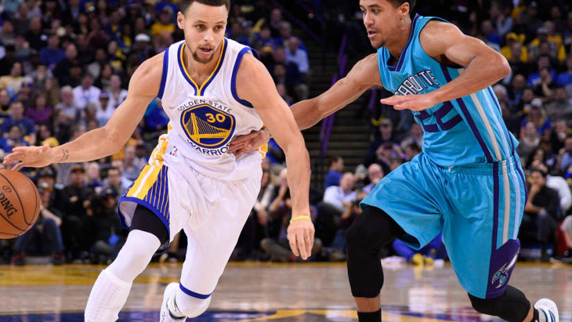 NBA and Golden State Warriors star Stephen Curry dribbles up the court