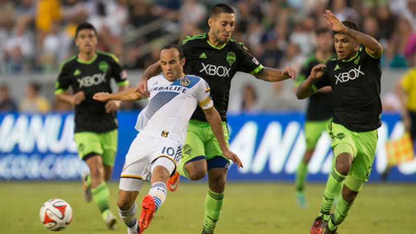 Clint Dempsey of the Seattle Sounders drags down Landon Donovan of the LA Galaxy