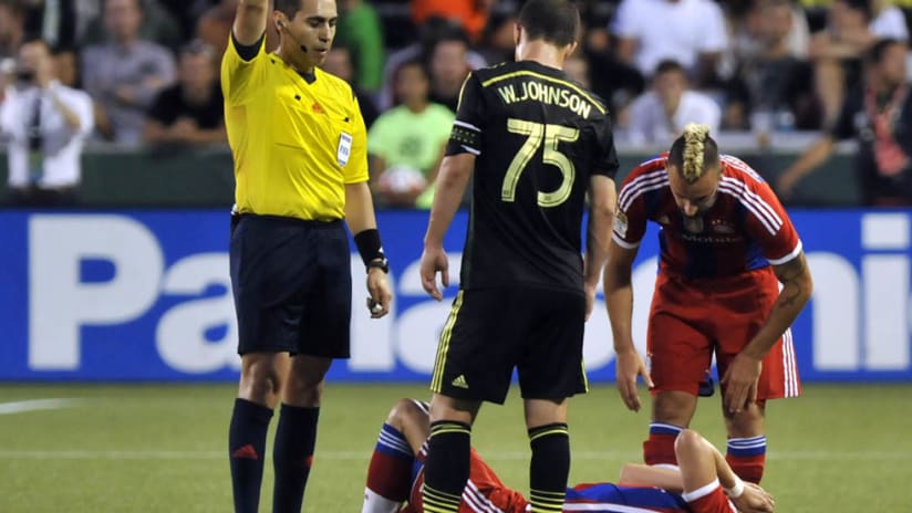 Will Johnson stands over Bastian Schweinsteiger after a foul during the 2014 MLS All-Star Game
