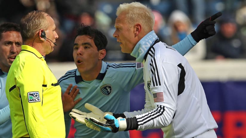 Sporting Kansas City's Omar Bravo (center) argues his red card foul in a 3-2 loss to the Chicago Fire on Saturday.