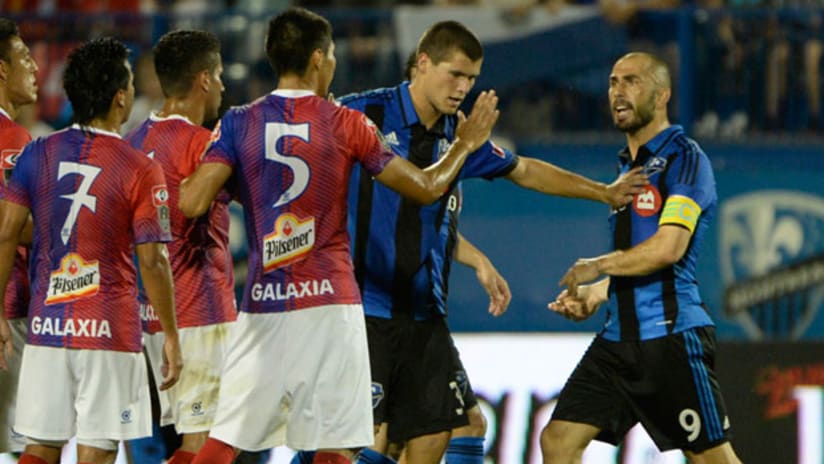 Montreal's Marco Di Vaio confronts a group of players from FAS