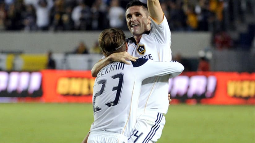 Galaxy forward Robbie Keane celebrates with David Beckham after scoring in his MLS debut.
