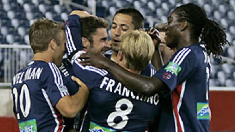 Revolution teammates surround Pat Noonan after he scored against the Red Bulls.