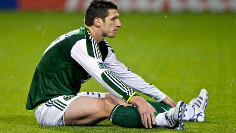 Portland's Kenny Cooper sits on the pitch during a 2-0 loss to Houston.