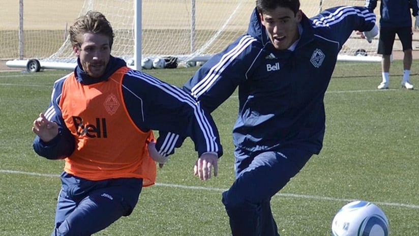 Omar Salgado (right) chases Vancouver teammate Jonathan Leather in Whitecaps training camp
