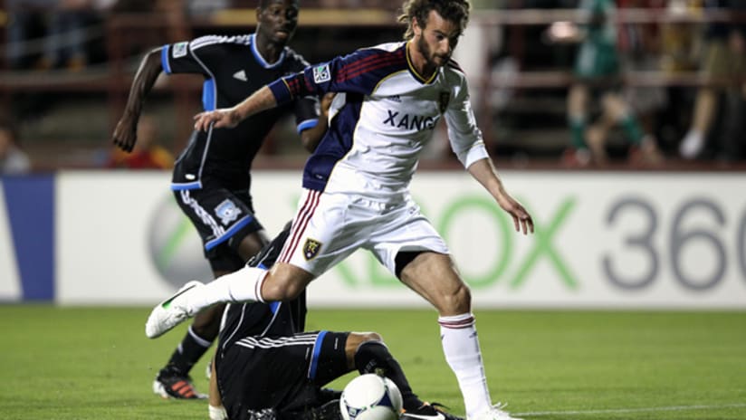 RSL's Kyle Beckerman slides by a pair of SJ defenders to score