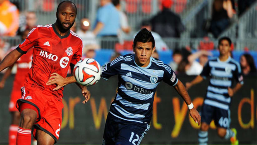Mikey Lopez, Sporting KC, races with Toronto FC's Collen Warner for a loose ball.