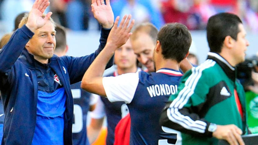 Jurgen Klinsmann high-fives USMNT's Chris Wondolowski