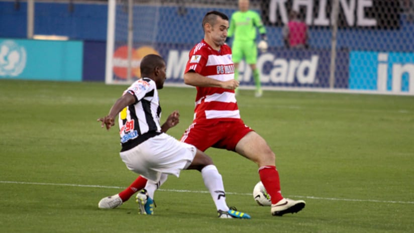 FC Dallas' Andrew Jacobson defends against a Tauro FC attacker.