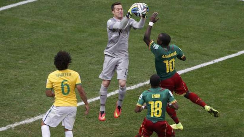 Julio Cesar claims the ball in Brazil's World Cup game against Cameroon