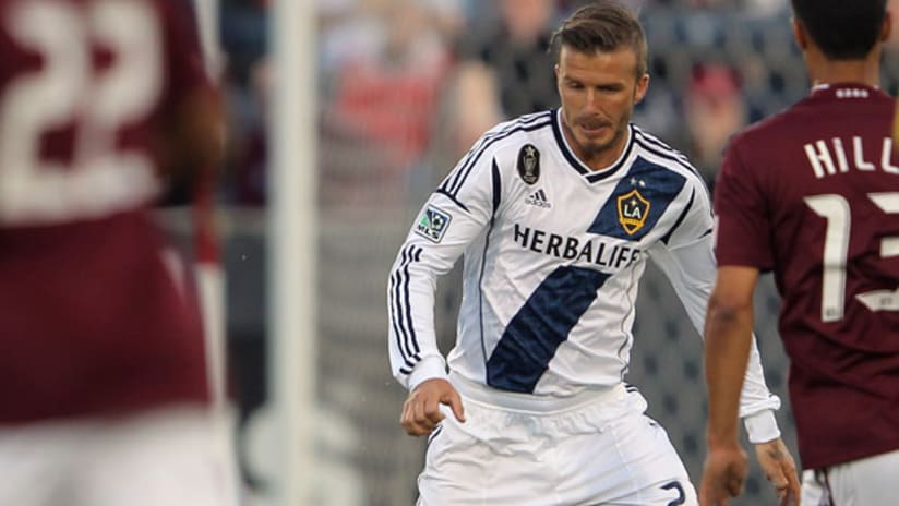 LA Galaxy's David Beckham faces two Colorado Rapids defenders, April 21, 2012.