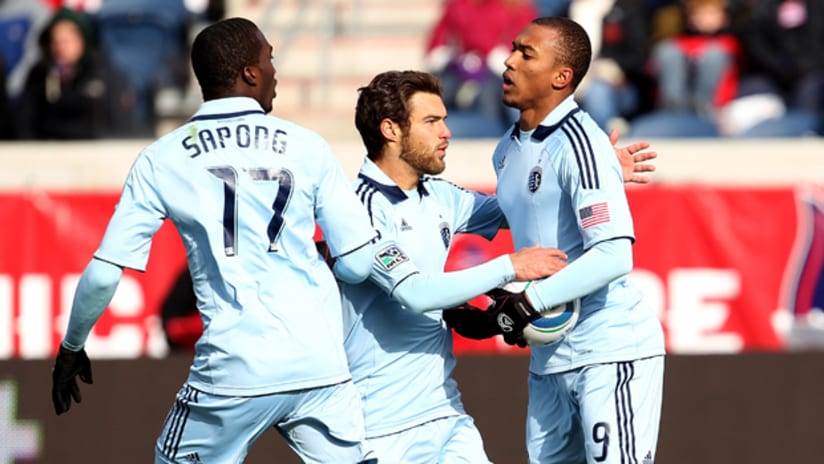 Teal Bunbury celebrates with CJ Sapong and Graham Zusi after scoring for Sporting against Chicago