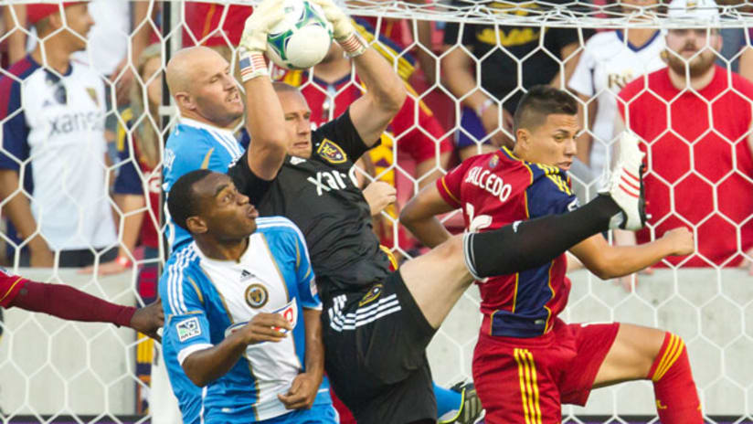 Josh Saunders makes a save as Conor Casey, Amobi Okugo and Carlos Salcedo look on
