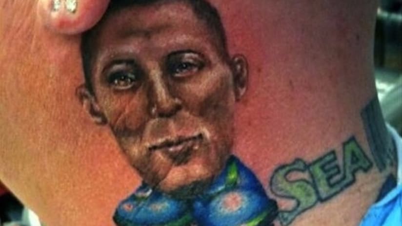 Tattoo of Clint Dempsey on someone's neck