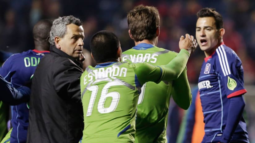 Chicago Fire head coach Frank Klopas (left) tries to hold Seattle's David Estrada back from a melee against the Chicago Fire.