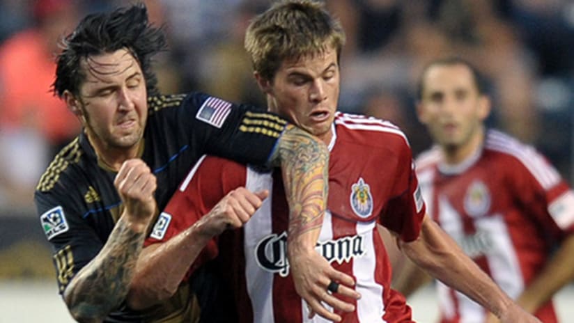 Danny Califf of the Philadelphia Union and Justin Braun of Chivas USA battle for the ball.