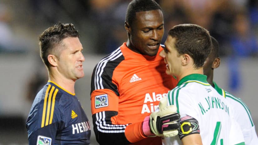 LA Galaxy's Robbie Keane squares up with Portland's Donovan Ricketts and Will Johnson