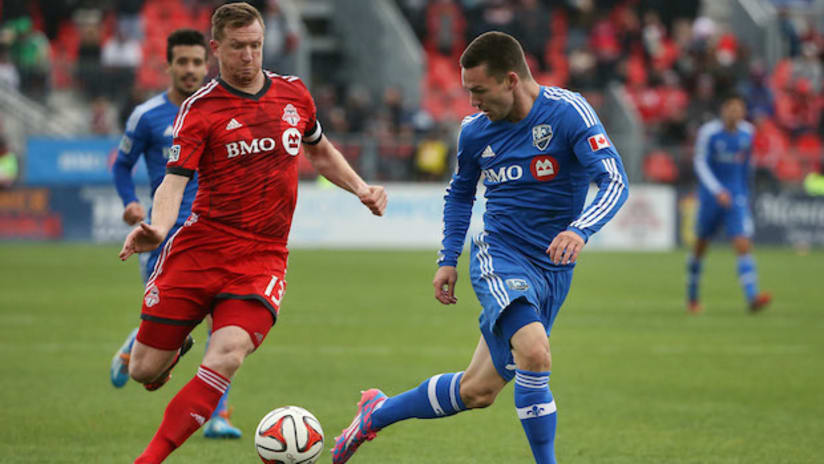 Jack McInerney (Montreal Impact) and Steven Caldwell (Toronto FC) in 2014