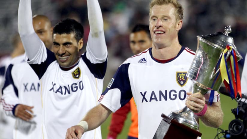 RSL's Nat Borchers holds the Rocky Mountain Cup trophy after a 0-0 draw vs. Colorado