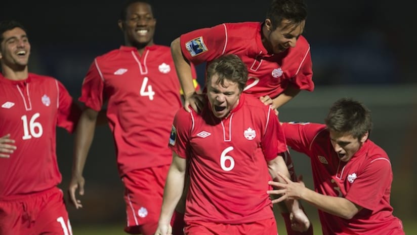 Samuel Piette (No. 6) celebrates his goal with Canada teammates