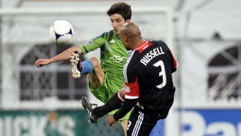 Seattle's Alvaro Fernandez and D.C. United's Robbie Russell battle for the ball