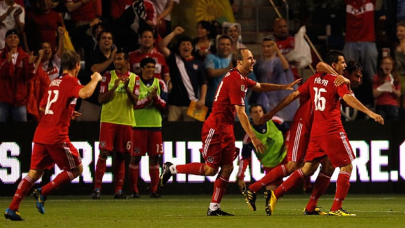 Fire players mob Marco Pappa (16) after his second-half goal on Saturday night at Toyota Park.